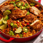 A hearty one pot Mexican chicken and rice dish loaded with seasoned chicken, fluffy rice, black beans, corn, peppers, and fresh cilantro, served straight from the pot.