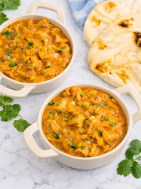 Slow Cooker Butter Chicken served over basmati rice with fresh cilantro garnish